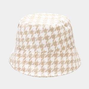 Detailed close-up of the thick houndstooth texture on a stylish women's winter bucket hat