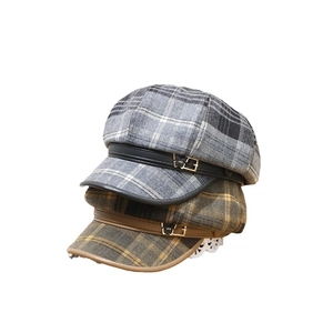 Vintage wool newsboy hat in black grey and tan plaid pattern with metal bow buckle