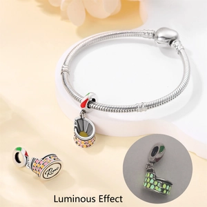 Detailed view of silver snake chain bracelet with luminous Rome Colosseum charm