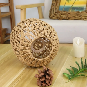 Detail of hand-woven spherical rattan lampshade with internal metal frame and mesh texture