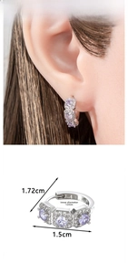 Detail of silver hoop earrings with purple zircon stones and size specifications
