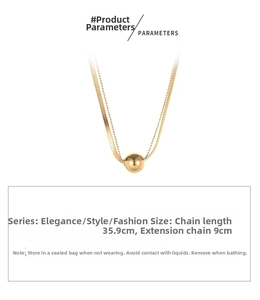 Detail showing gold double-layer chain necklace with smooth ball pendant and size parameters