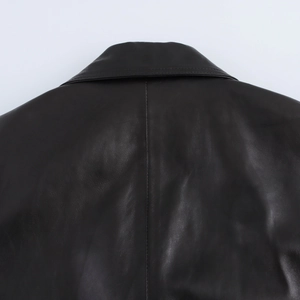 Detail of the back collar and stitching on this loose black PU leather jacket