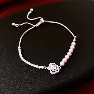 Elegant silver bracelet with zircon, white pearls and a delicate rose flower pendant