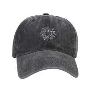 Detailed view of sun and moon embroidery on washed charcoal cotton baseball cap