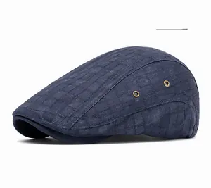Detailed macro view of navy blue plaid fabric and brass ventilation eyelets on the hat