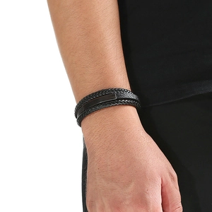Close-up of black multilayer braided leather bracelet with magnetic metal clasp on wrist