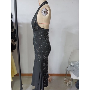 Detail of a black halter neck evening gown with shimmering multi-colored rhinestones