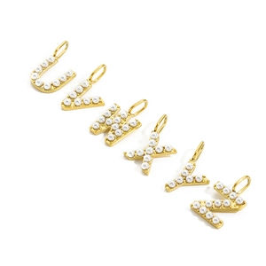 Detailed view of gold-tone initial charms U to Z featuring elegant faux pearl inlays