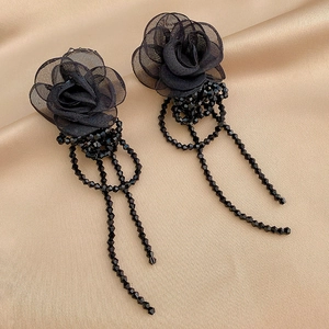 Elegant vintage black lace rose earrings with crystal tassels on champagne silk