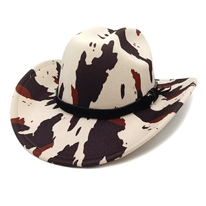 Classic western cowboy hat with black and white cow print and decorative metal buckle band