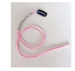 Pink hair braid rope with silver metal bead and black snap clip on white surface
