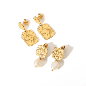 Hammered gold square earrings and freshwater pearl drop studs on white background