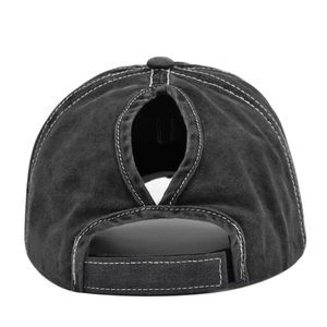 Detail of washed grey baseball cap featuring a cross-opening for high ponytails