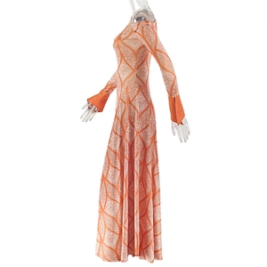 Close-up of the flared cuff and geometric orange pattern on the maxi dress fabric