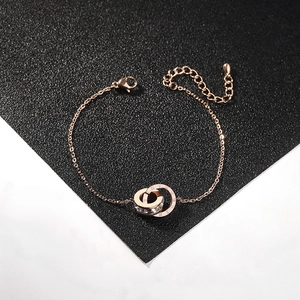 Detail of rose gold double ring bracelet with roman numerals and inlaid crystals