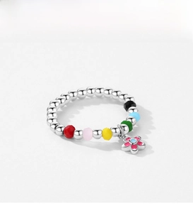 Close-up of S925 silver beaded ring with colorful facets and a floral enamel charm