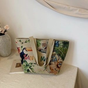 Detail of linen tote bag featuring tropical animal prints with toucan and leopard patterns