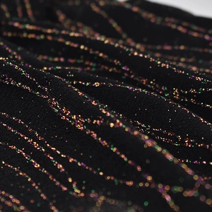 Women's black knitted hat with shimmering gold metallic stripes and colorful glitter detail
