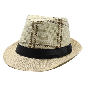 Detailed close-up of woven straw fedora hat featuring a brown plaid pattern and black band