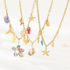 Summer beach style layered gold necklace featuring conch, starfish, and shell pendants
