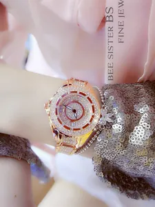 Close-up of luxury gold women's watch with full crystal rhinestones on a wrist