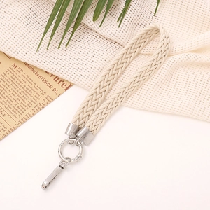 Detail of beige woven cotton wrist strap with silver metal ring and lobster clasp