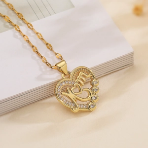 Macro di un ciondolo a cuore MOM placcato oro 18K con zirconi su un libro bianco