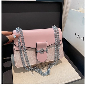 Elegant pink flap bag featuring a silver chain strap and a rose-shaped metal clasp