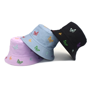 Three embroidered butterfly cotton bucket hats in purple, blue, and black colors