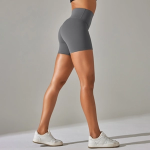 Macro view of high-waist yoga shorts showing flexible moisture-wicking fabric and fit