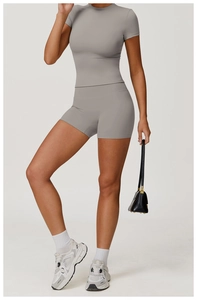 Detailed view of high-waist yoga shorts and short sleeve top in grey brushed fabric