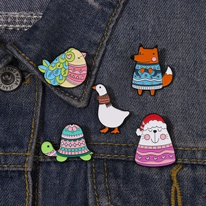 Close-up of cute cartoon animal enamel pins on a blue denim jacket pocket