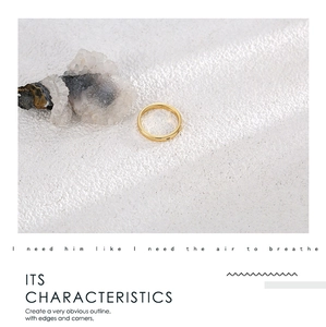 Close-up of minimalist 18K gold plated ring on white stone with clear quartz crystal