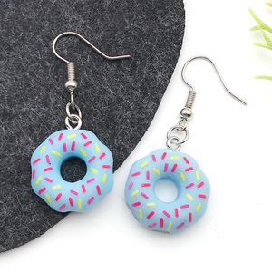 Pair of blue resin donut earrings with colorful sprinkles on silver metal hooks