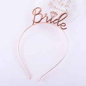 Detail of rose gold Bride crown featuring hollow metal lettering and diamond icon design