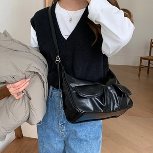 Retro black faux leather baguette shoulder bag with front pockets on model
