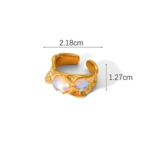 Detail view of gold adjustable ring with lava texture and iridescent moonstone cabochons