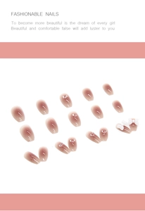 Detail of nude gradient press-on nails with 3D white bows and crystal heart accents