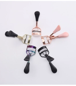 Detailed view of five portable stainless steel eyelash curlers in various colors and finishes
