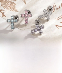 Macro shot of titanium steel cross stud earrings with micro-set colorful zircon stones