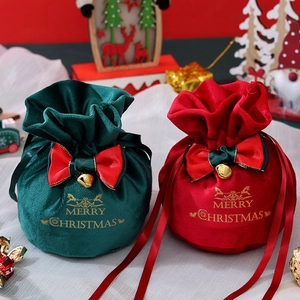 Velvet Christmas drawstring gift bags with gold foil print and ribbon bow accents