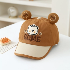 Detail of kids baseball cap with brown bear ears, SOME embroidery and Hello smiley face