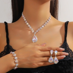Close-up of model wearing colorful rhinestone necklace, bracelet, and earring set