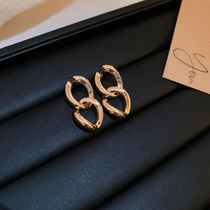 Luxurious gold double oval link earrings displayed elegantly on a black jewelry tray