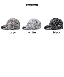 Detailed view of grey white and black baseball caps with abstract line art print