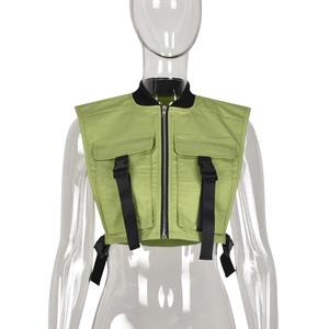 Detail of green utility vest featuring black nylon straps and plastic buckles closure