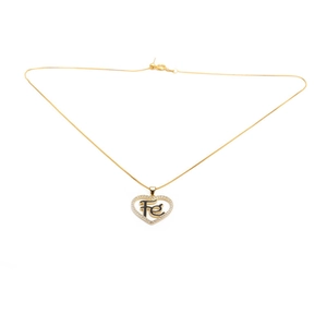 Golden heart necklace with Fé faith pendant and micro-set crystals on white background