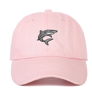 Pink cotton baseball cap featuring detailed shark embroidery on a classic curved brim hat