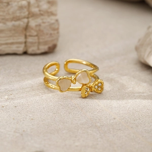 Macro detail of gold double-layer butterfly ring with cat eye stone and crystal accents